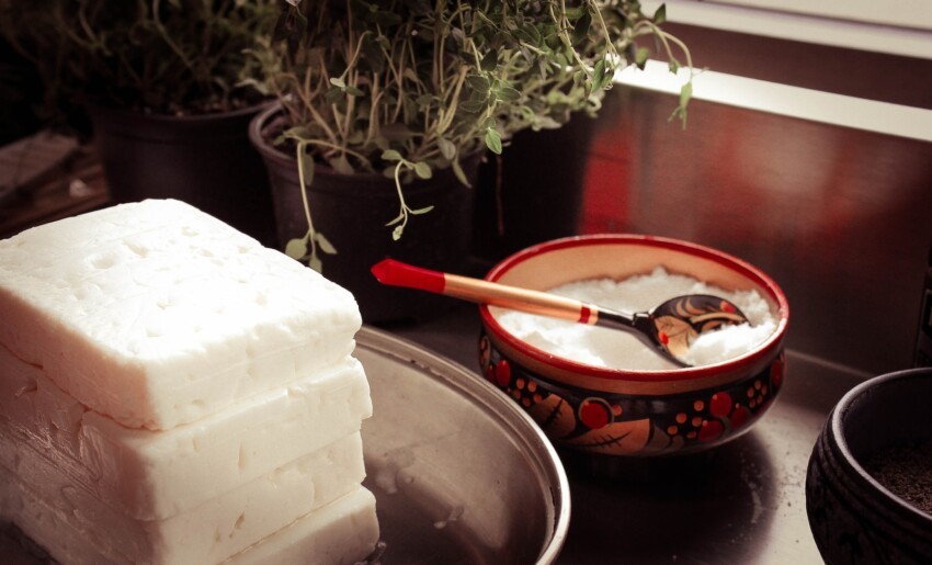red ceramic bowl on gray spoon feta cheese