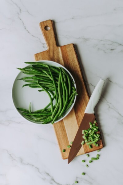 green and white vegetable on brown wooden chopping board